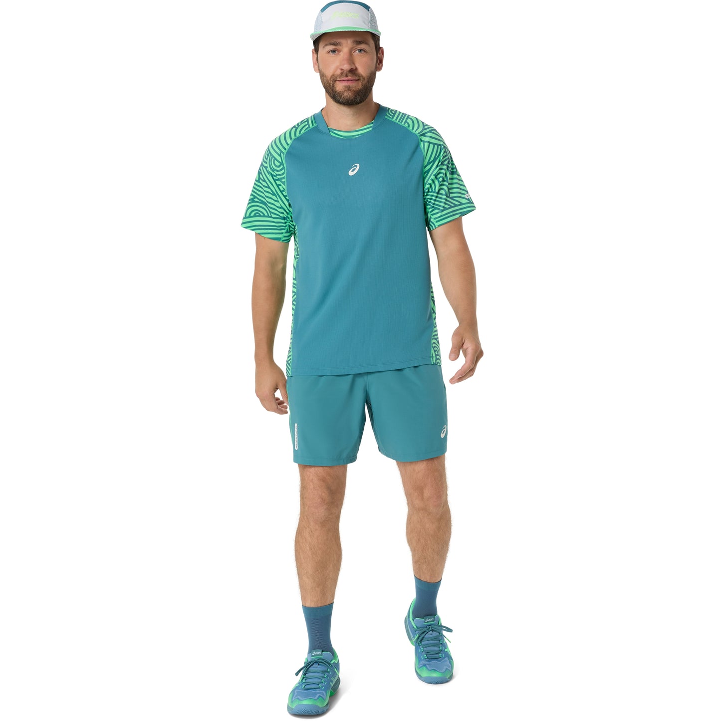 Man wearing a teal athletic outfit with a logo on a white background