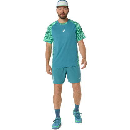 Man wearing a teal athletic outfit with a logo on a white background