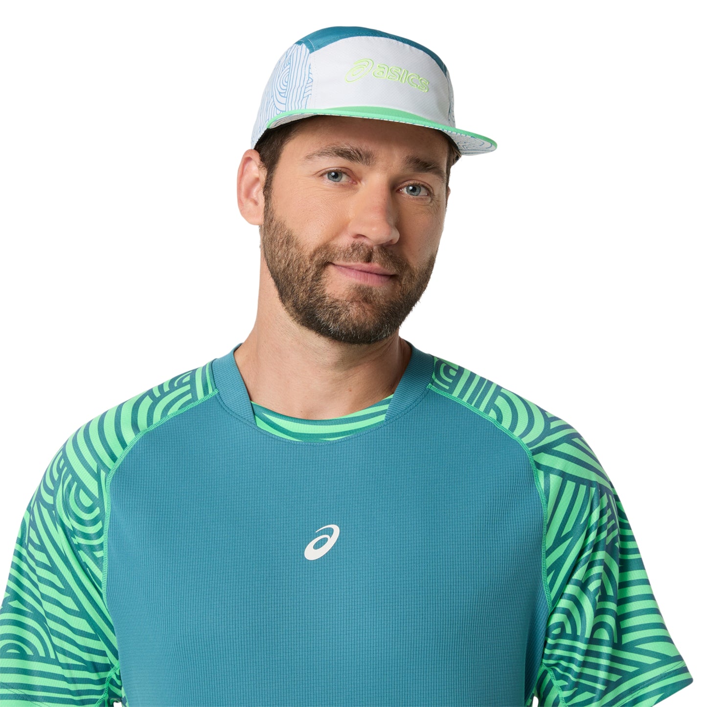 Man wearing a teal and green athletic shirt with a cap on a white background