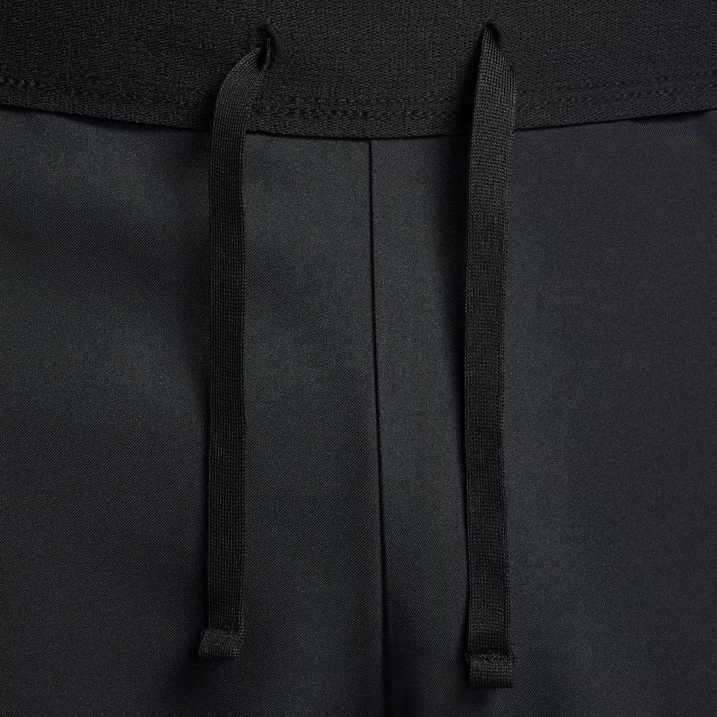Close-up of black drawstrings on a black short