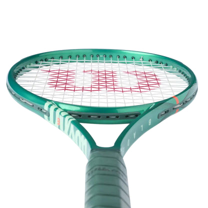 Green Wilson tennis racket with white strings on a white background