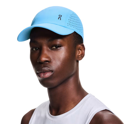 Man wearing a blue On cap on a white background