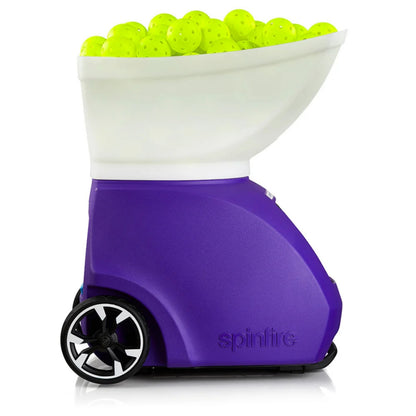 Purple Spinfire tennis ball machine with a white top filled with green balls on a white background