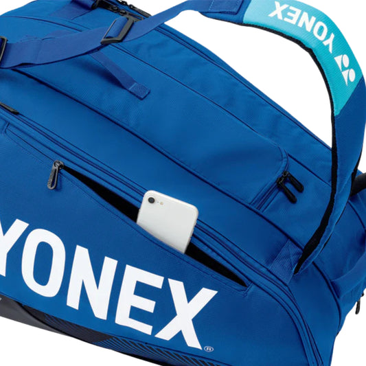 Blue Yonex bag with a phone inside on a white background