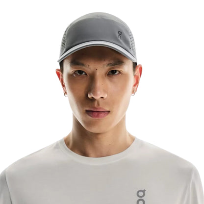 Man wearing a grey On cap on a white background
