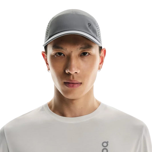 Man wearing a grey On cap on a white background