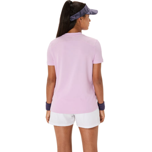 Woman wearing a light pink shirt and white shorts on a white background