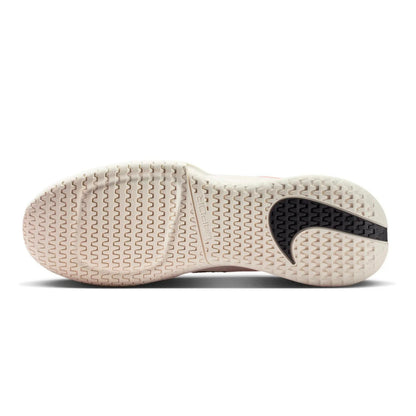 Bottome view of a Nike tennis shoe with a tread pattern on a white background