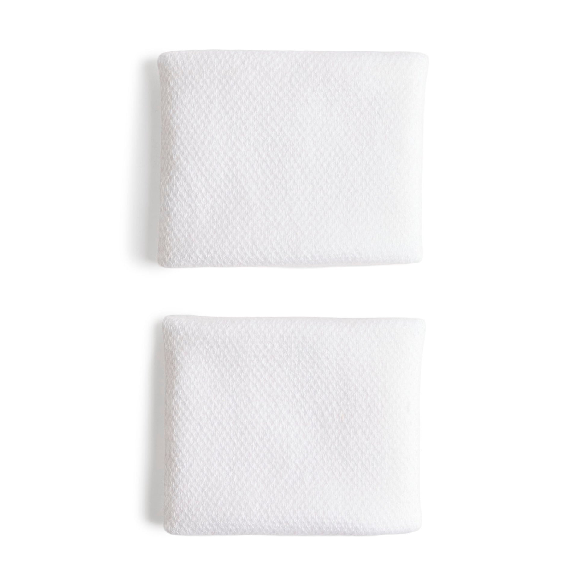 White adidas wristbands with a silver logo on a white bacground