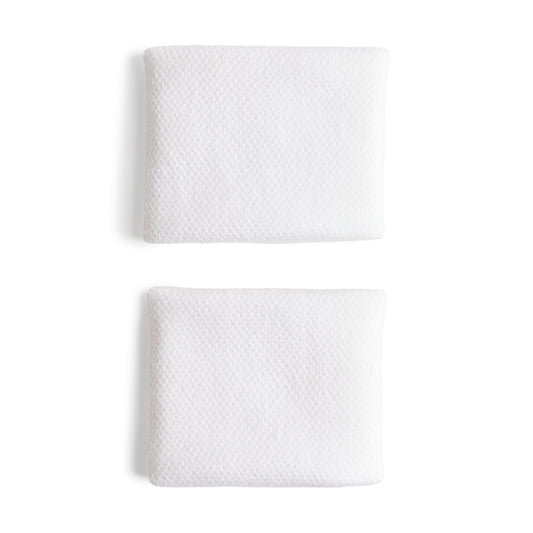 White adidas wristbands with a silver logo on a white bacground