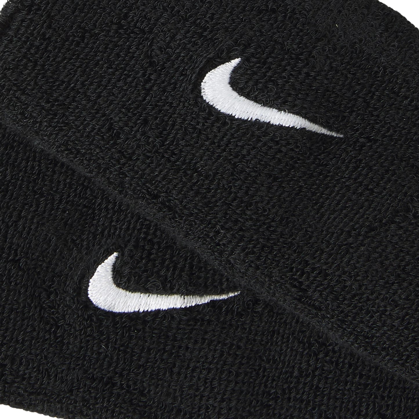 Two black wristbands with white Nike logos on a white background
