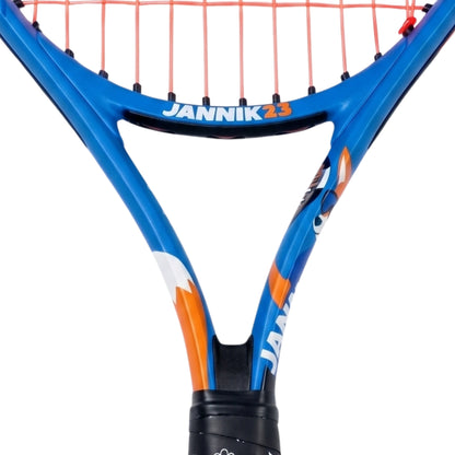 Close-up of a Jannik 23 Head tennis racket showing the blue frame with orange and white accents, orange strings, and a black grip against a white background.
