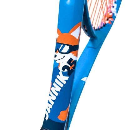Close-up of a blue Head Jannik 25 tennis racket frame featuring a cartoon fox wearing sunglasses and the brand name JANNIK 25 in white, with orange and white stringing visible at the throat.