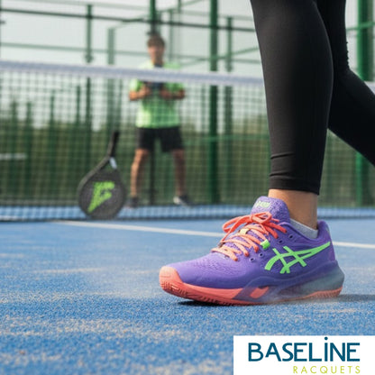 Person wearing a purple and pink sports shoe on a tennis court with 'BASELINE RACQUETS' branding.