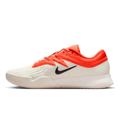 Orange, white and black Nike tennis shoe on a white background
