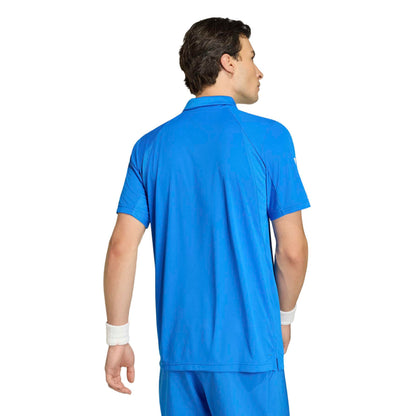 Man wearing a blue adidas polo shirt on a white background