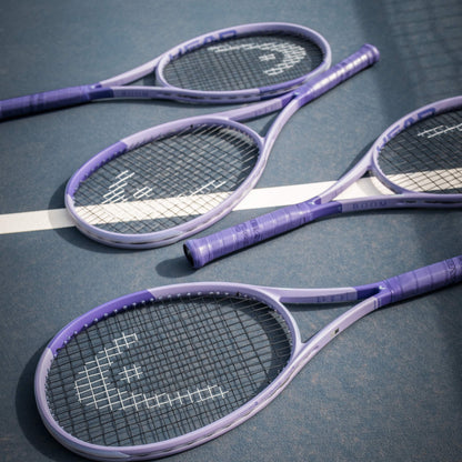 Four purple Head tennis rackets on a tennis court