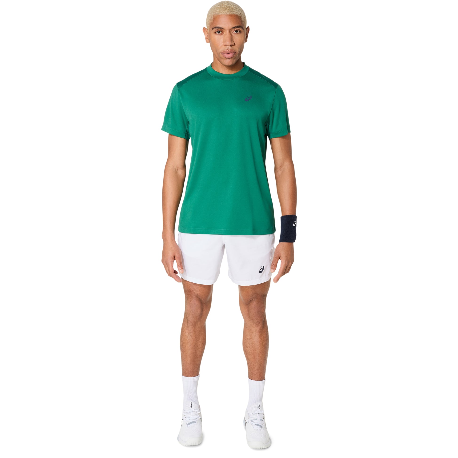 Man wearing a green athletic shirt and white shorts on a white background