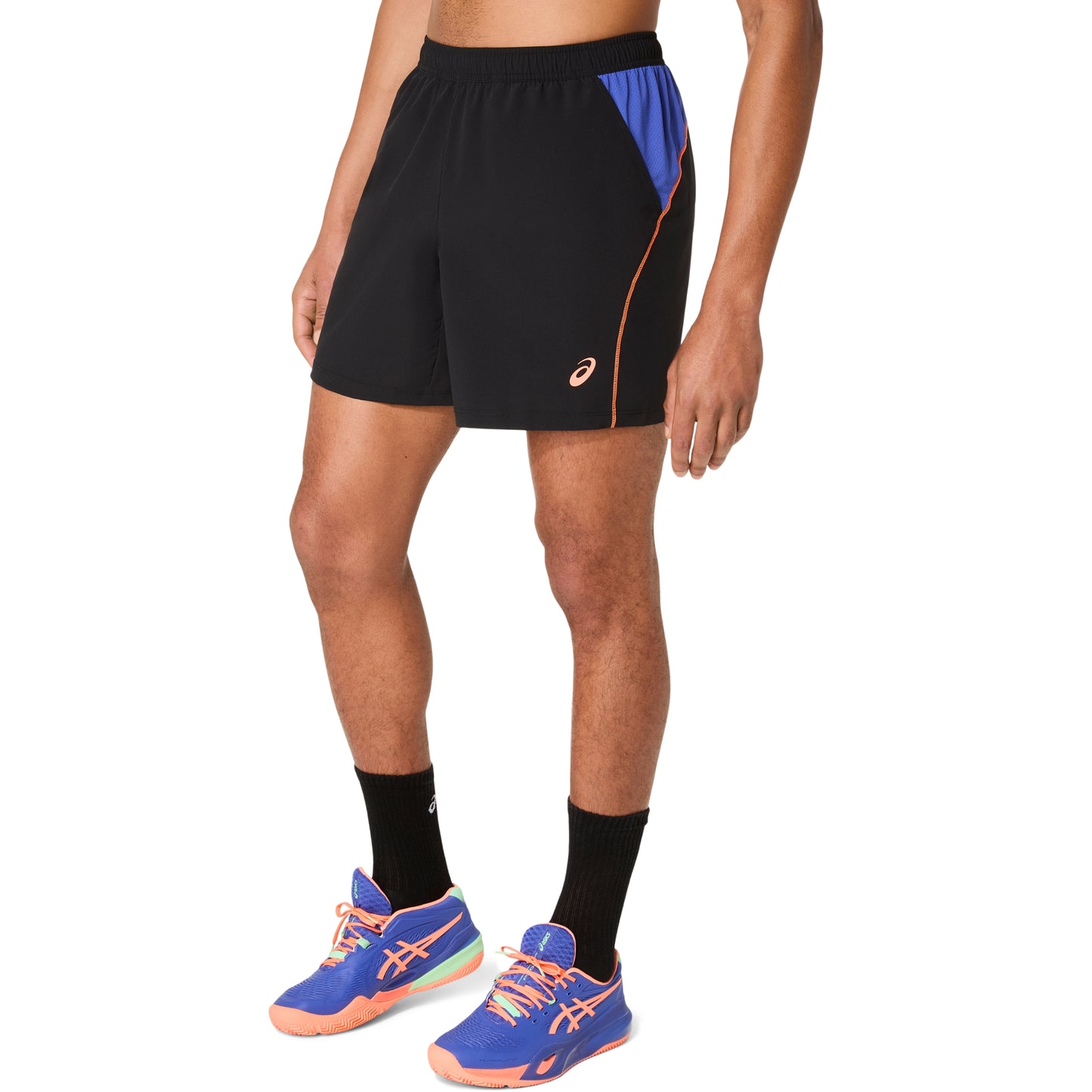 Person wearing black athletic shorts with blue accents and blue running shoes on a white background