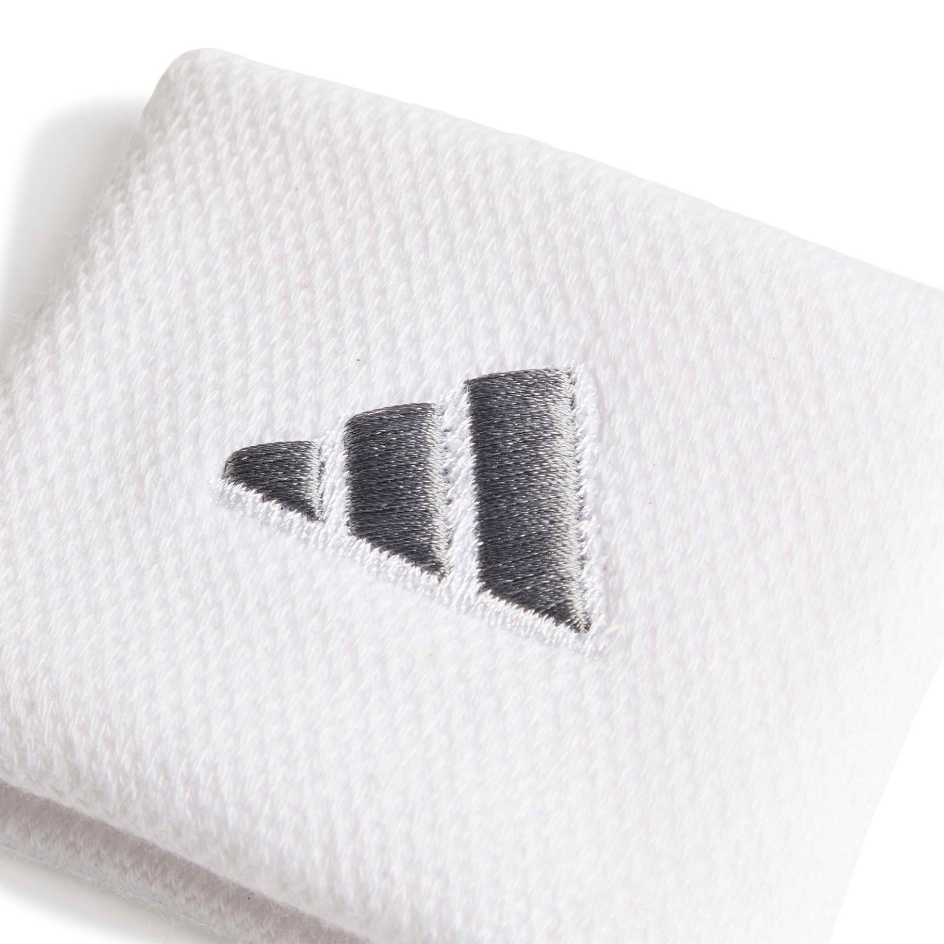 Close-up of a adidas white wristband with a silver logo on a white background
