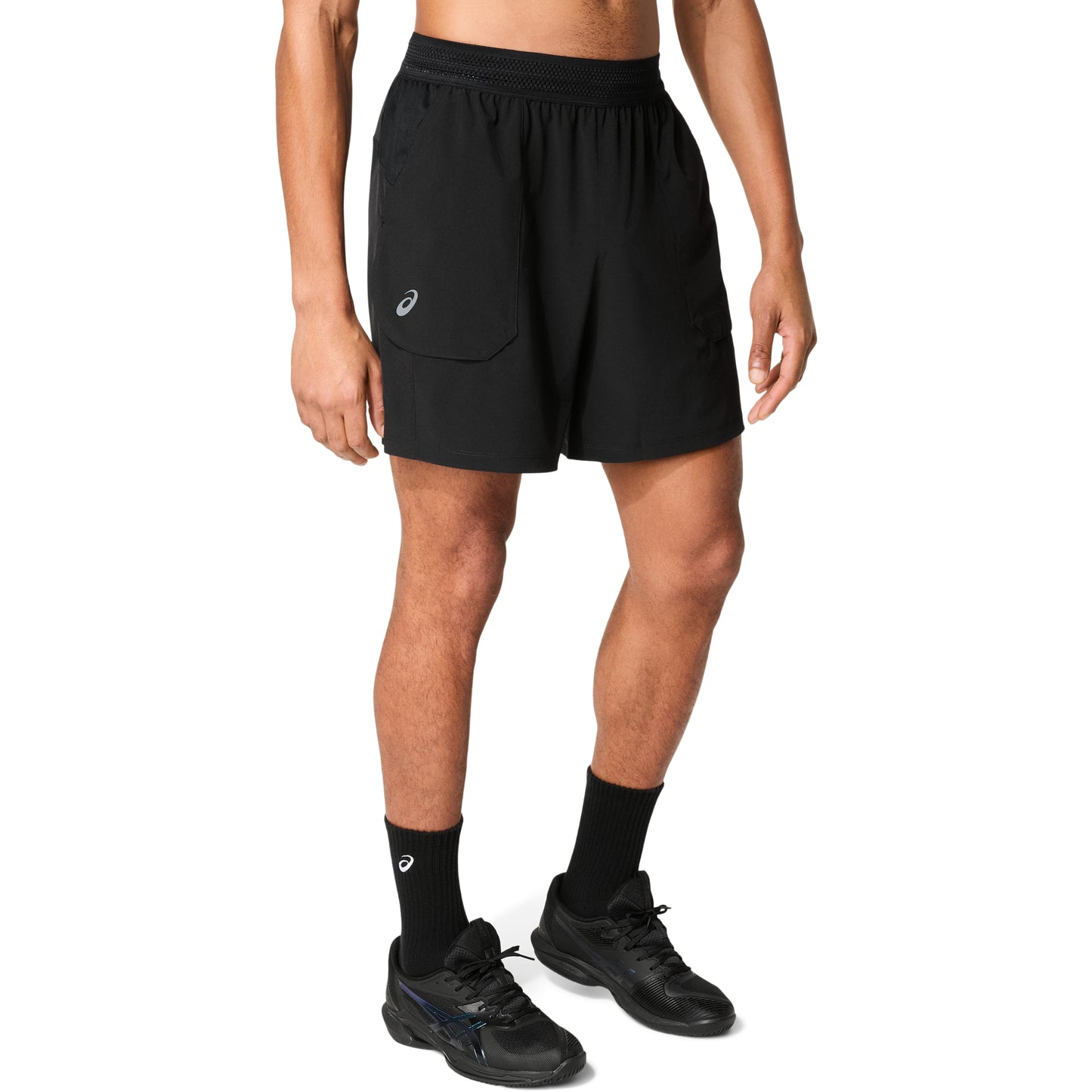 Man wearing black shorts with logo on right leg , on a white background