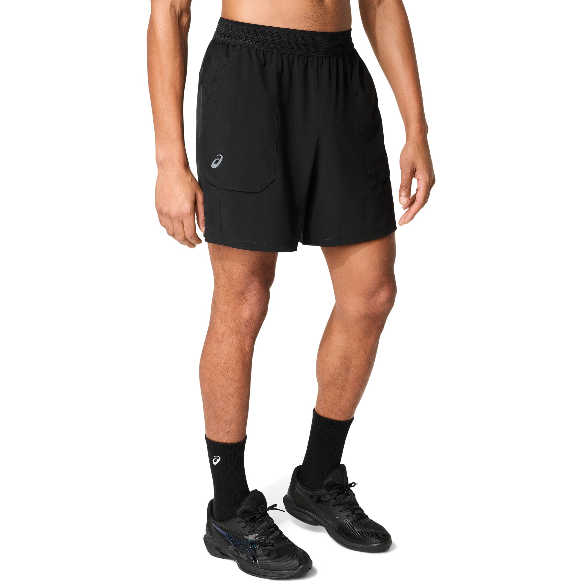 Man wearing black shorts with logo on right leg , on a white background