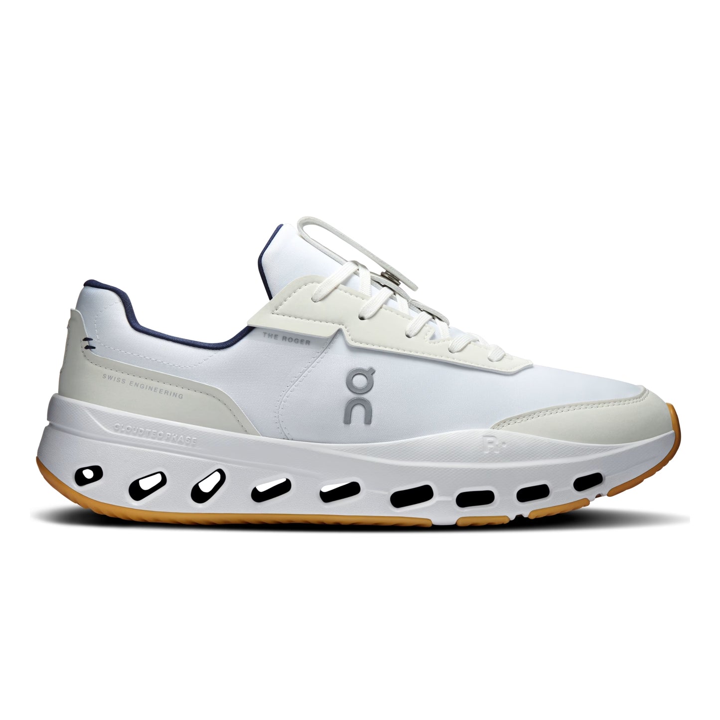 A white On tennis shoe with navy blue accents, a chunky white midsole with black cutouts, and a gum outsole, shown from a side profile on a white background.