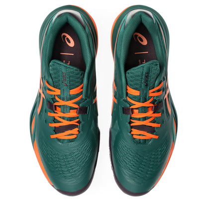 A dark green padel shoes with bright orange accents, including the ASICS logo and laces, shown in a side profile on a white background.