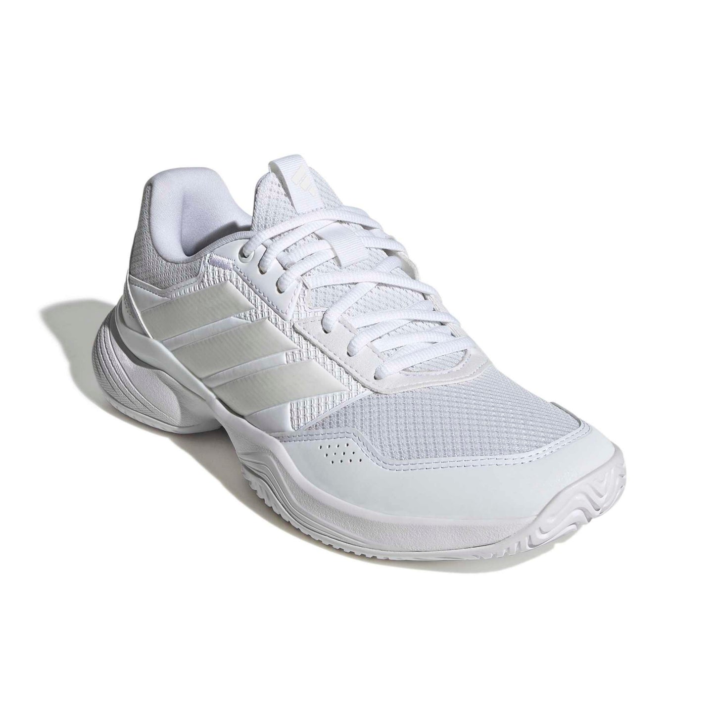 A white Adidas tennis shoe with white laces and white stripes, shown from a three-quarters angle on a white background with a soft shadow.