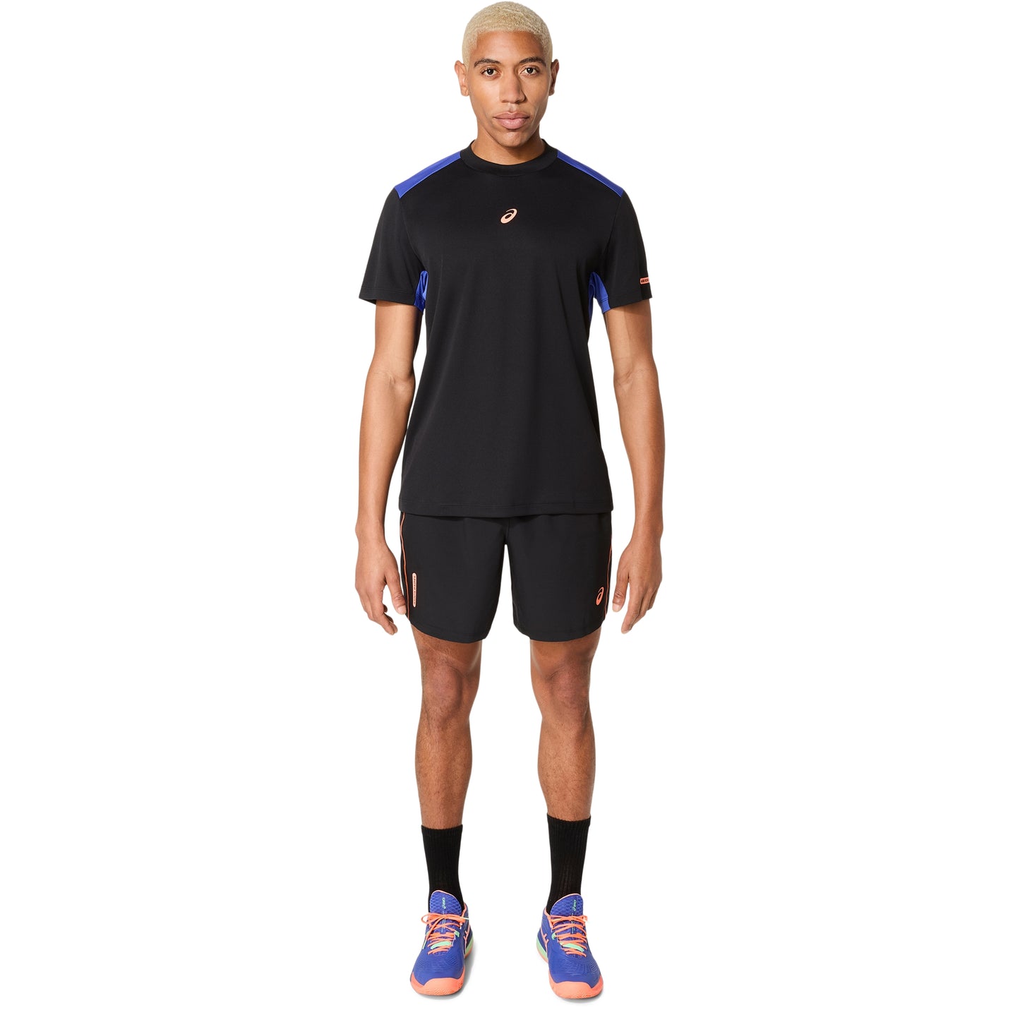 Person wearing a black athletic outfit with blue accents on a white background