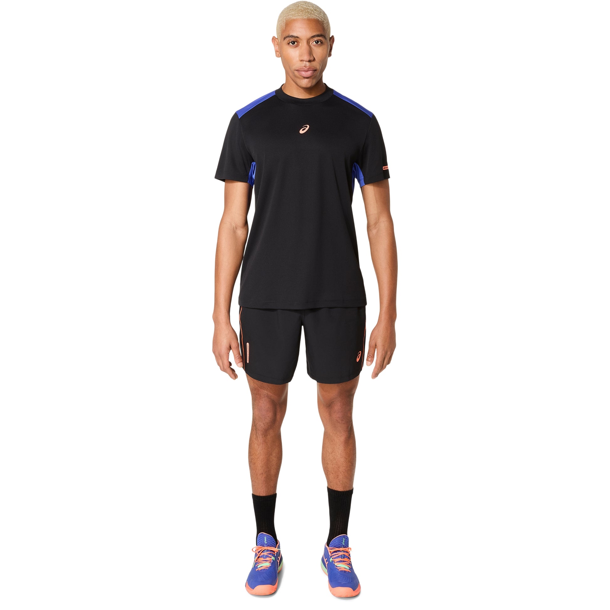 Person wearing a black athletic outfit with blue accents on a white background
