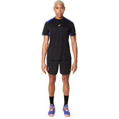 Person wearing a black athletic outfit with blue accents on a white background