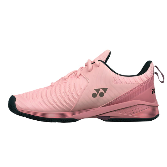 Pink Yonex tennis shoe with black accents on a white background
