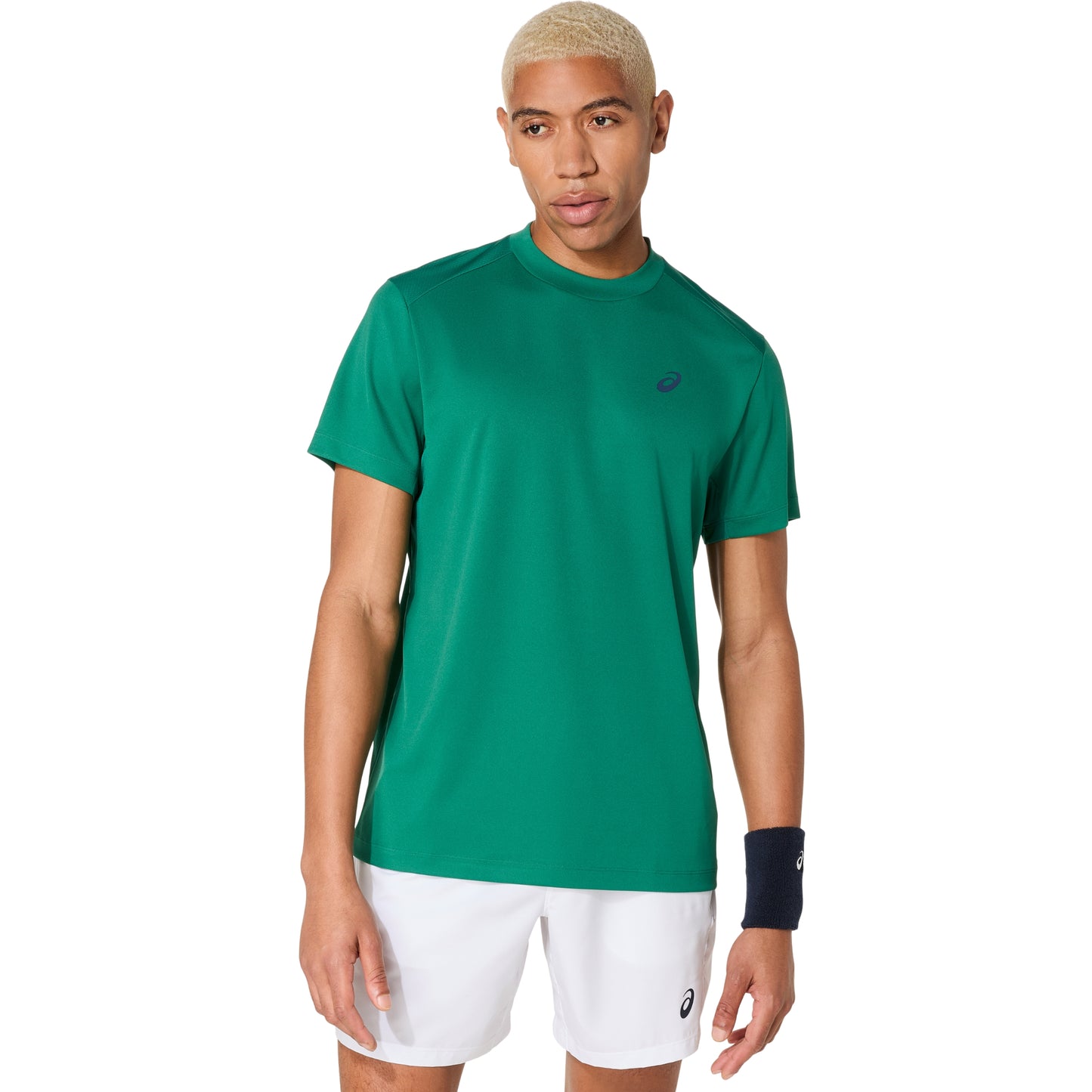 Person wearing a green Asics athletic shirt with a logo on a white background