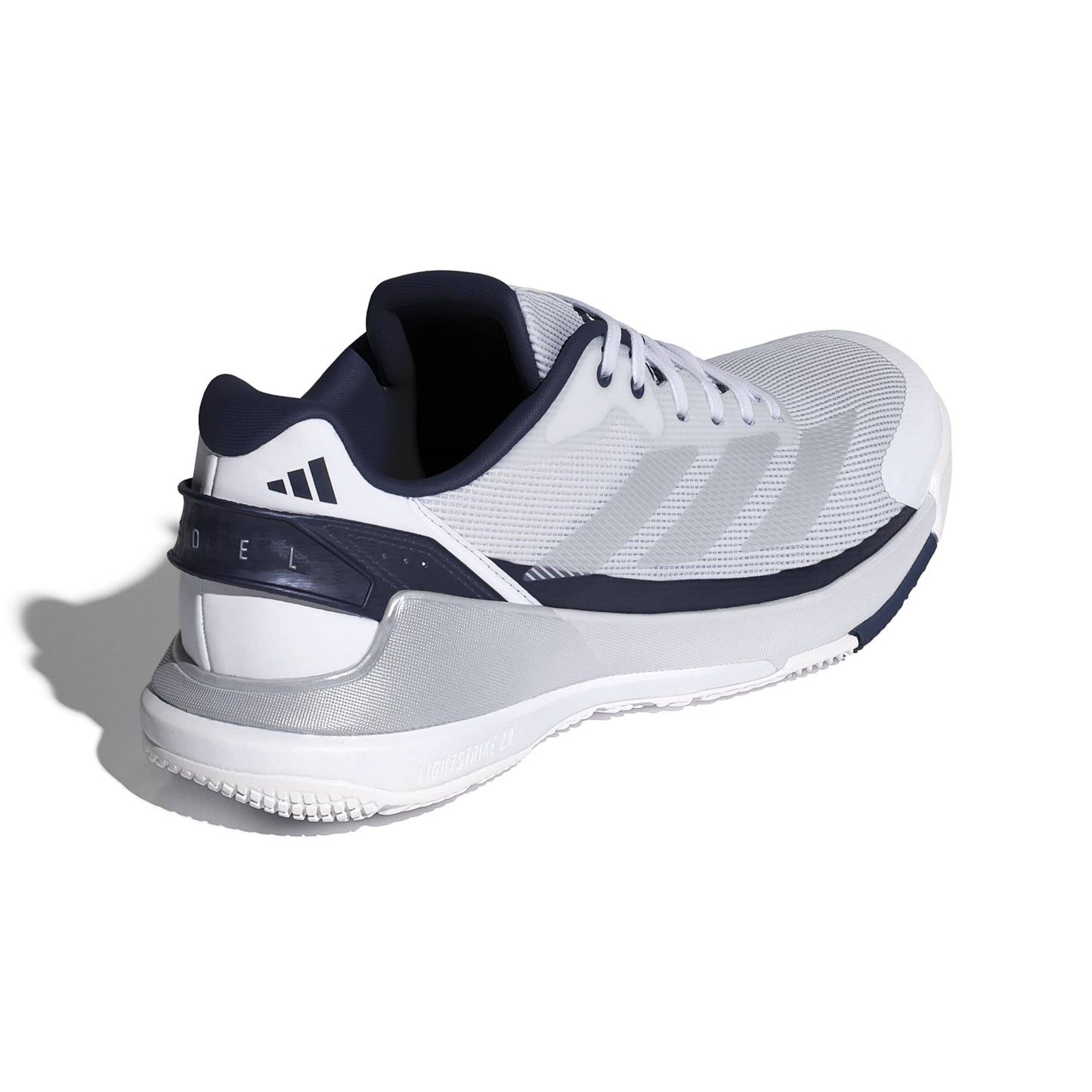 A white and navy blue Adidas padel shoe shown from a three-quarters rear angle on a white background with a soft shadow.