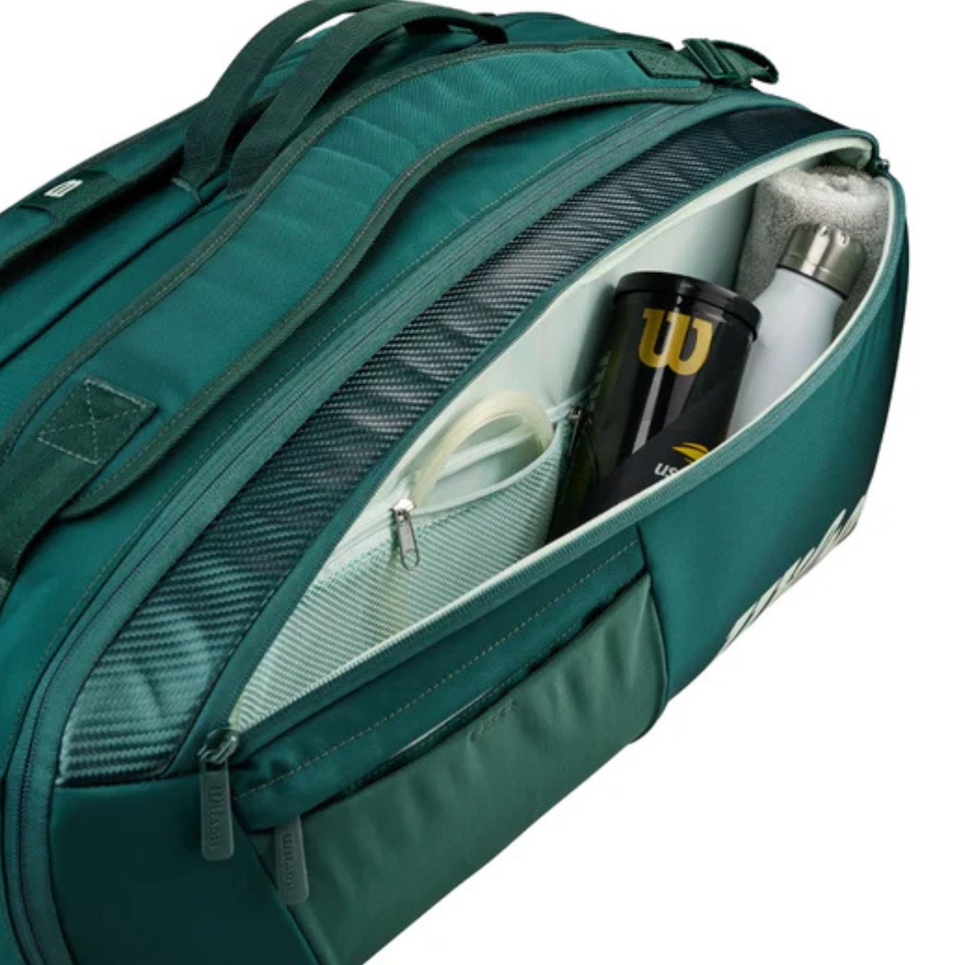 Green tennis bag with compartments containing a black cup and white bottle.