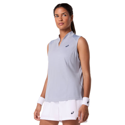 Woman wearing a light gray sleeveless Asics top and white shorts with a visible brand logo on a white background