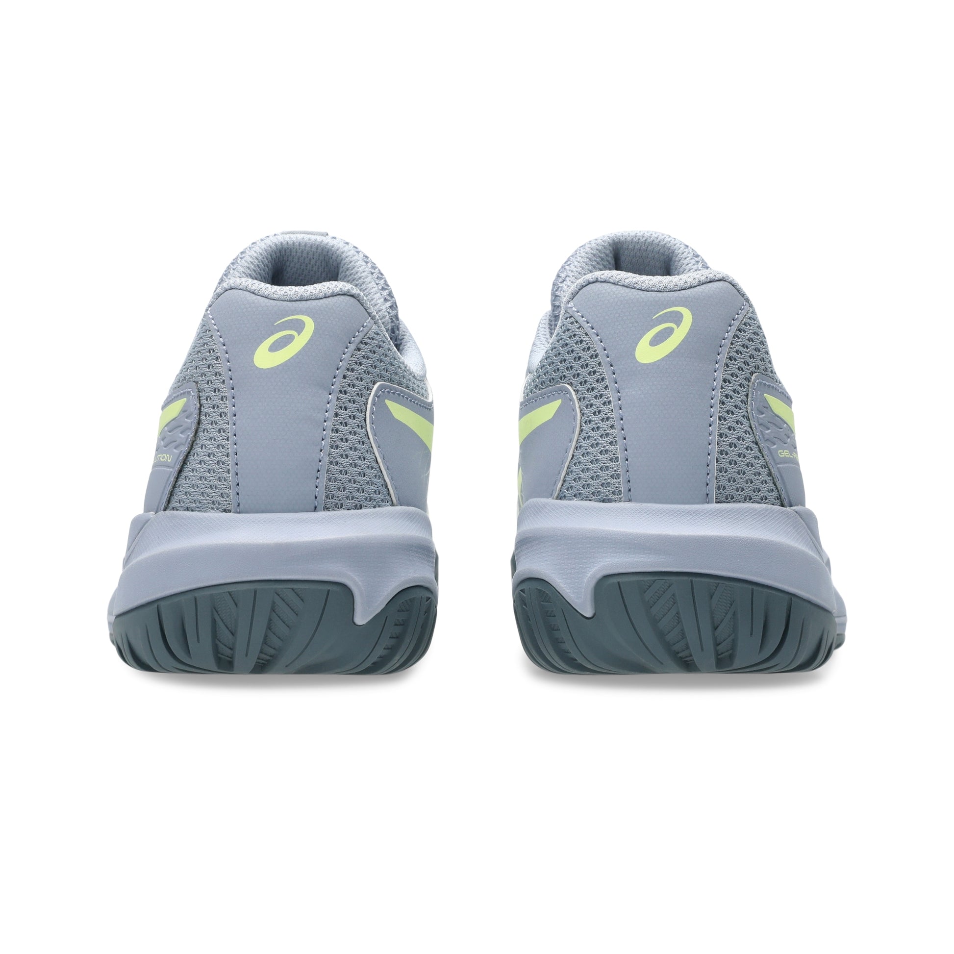 Gray tennis shoes with yellow accents on a white background