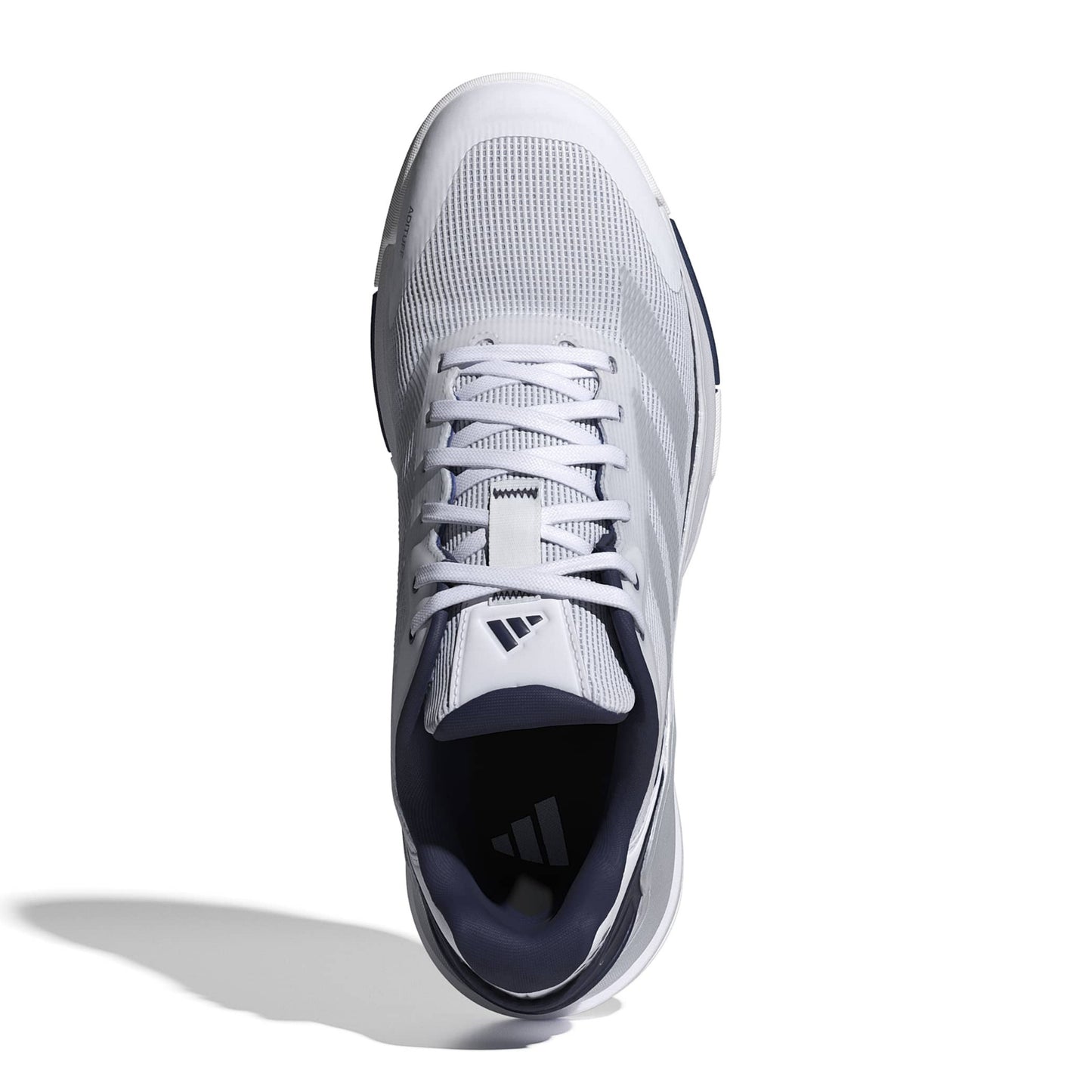 A single Adidas padel shoe shown from a top-down view on a white background with a soft shadow. The shoe is primarily white with a dark navy blue collar and tongue label.