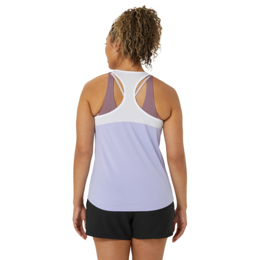 Woman wearing a two-tone tank top with a white and purple design on a white background
