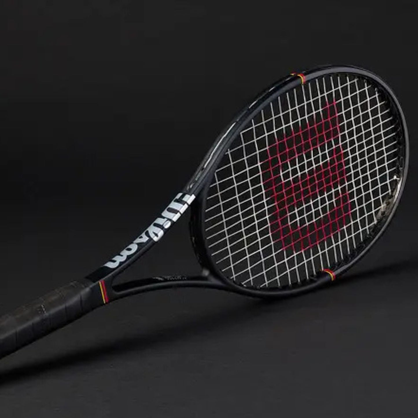 Tennis racket with Wilson branding on a black background