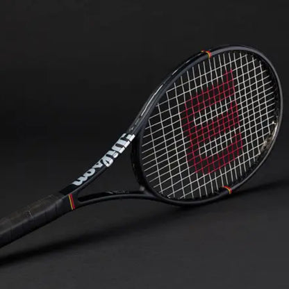 Tennis racket with Wilson branding on a black background