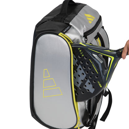 Gray and black tennis racket bag with a racket held by a hand on a white background
