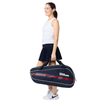 Woman holding a Wilson tennis bag on a white background