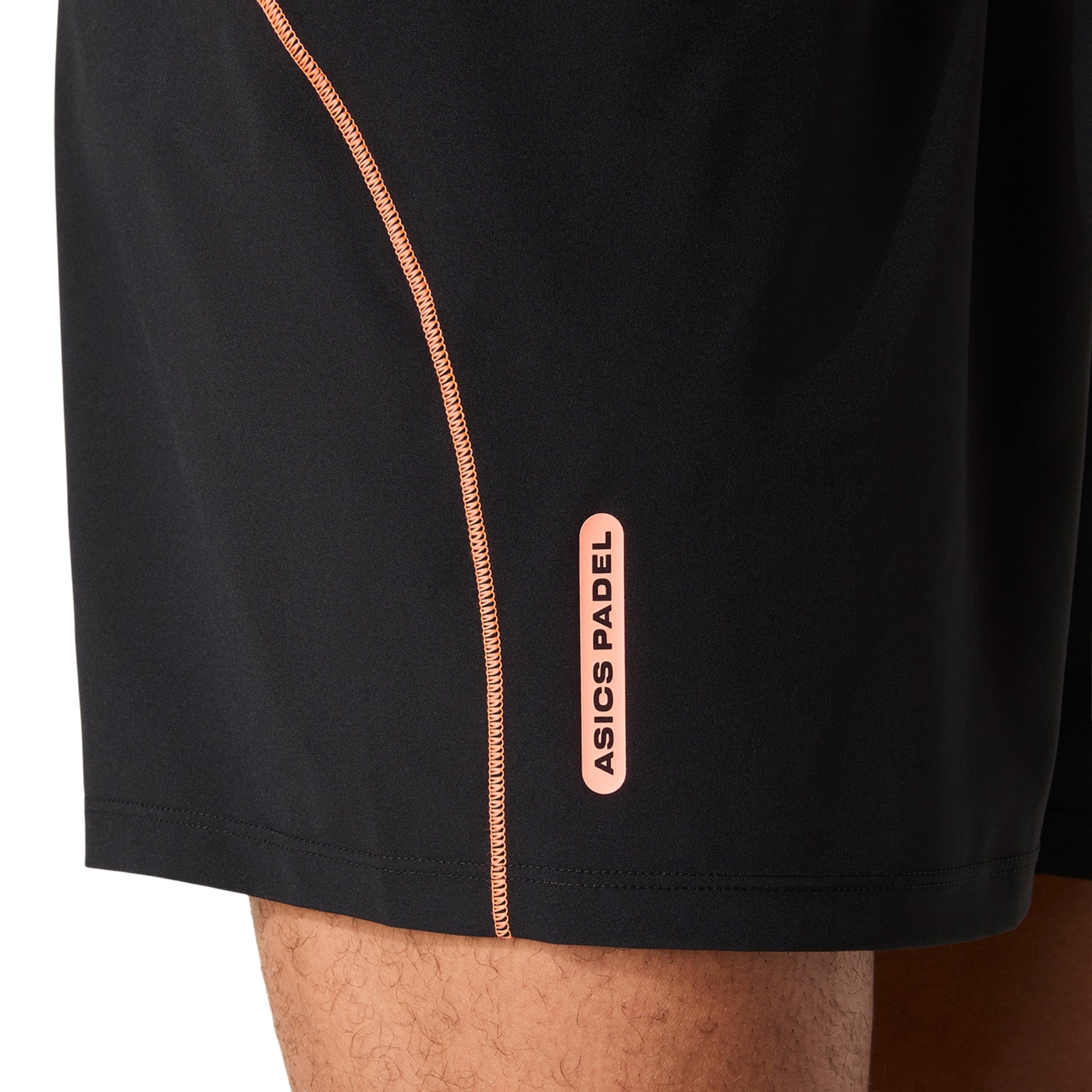 Black shorts with a Asics Padel logo on a white background