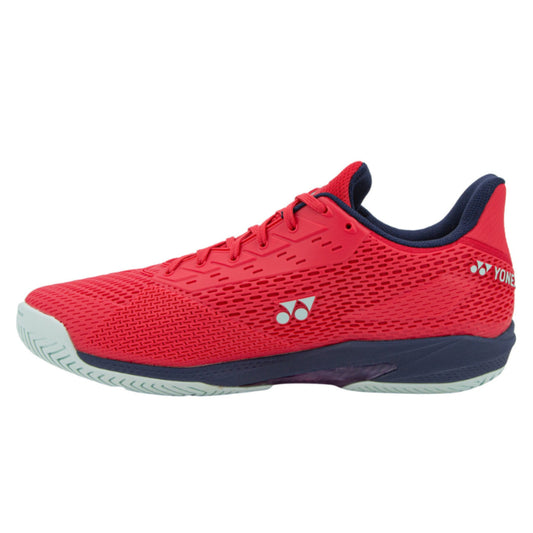 Red Yonex tennis shoe with navy accents on a white background