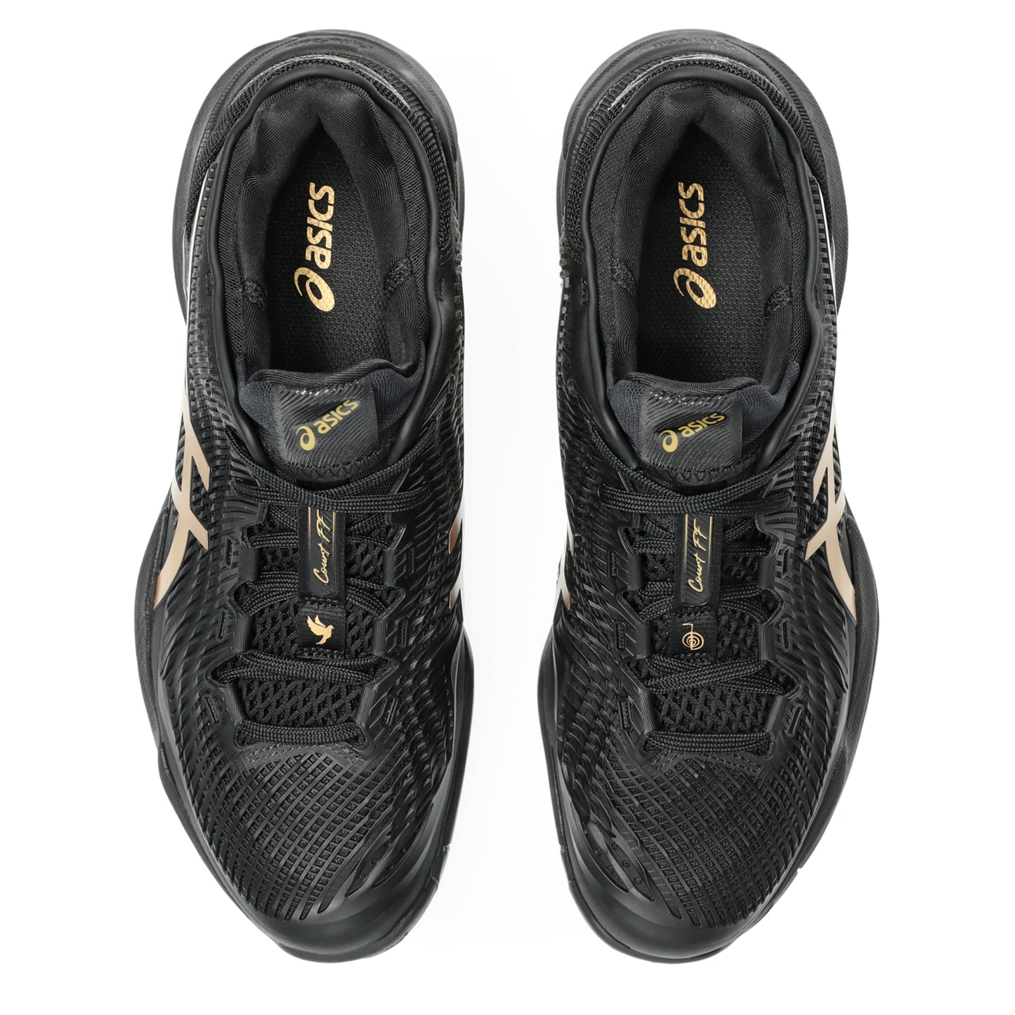 Black tennis shoes with gold accents on a white background