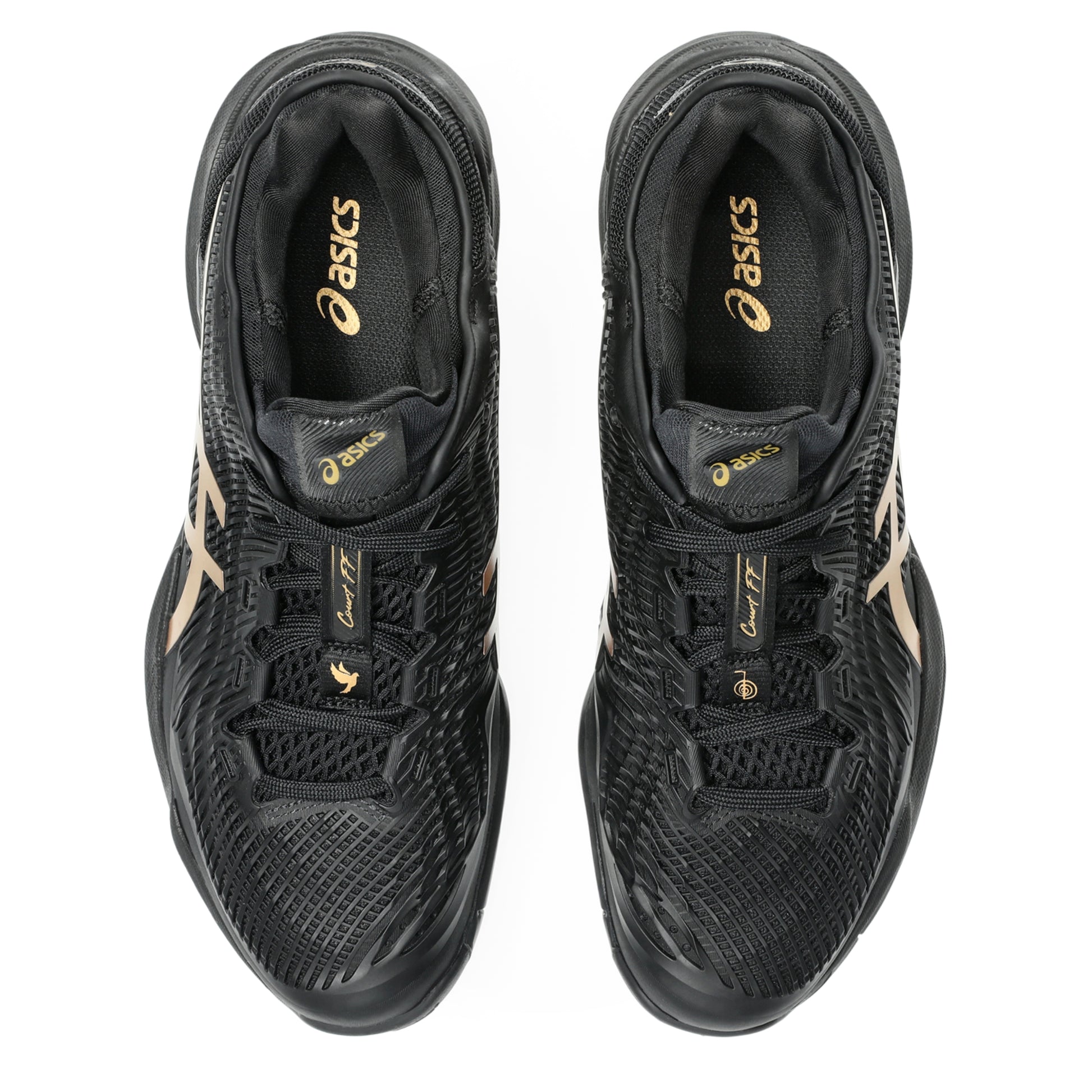 Black tennis shoes with gold accents on a white background