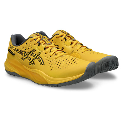 A pair of yellow Asics tennis shoes with black accents, including the ASICS logo, laces, and outsole, shown on a clean white background.
