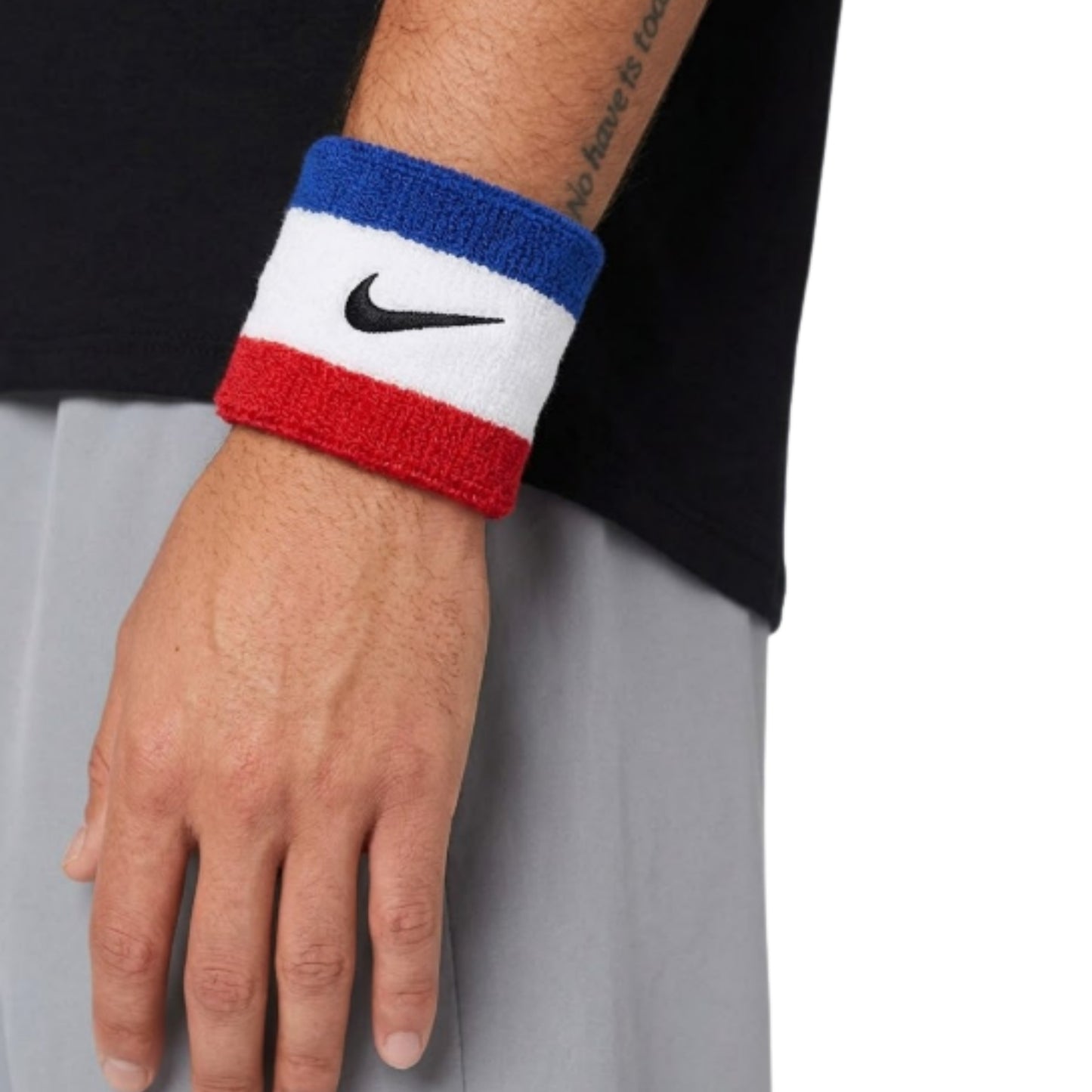 Person wearing a Nike wristband on a neutral background